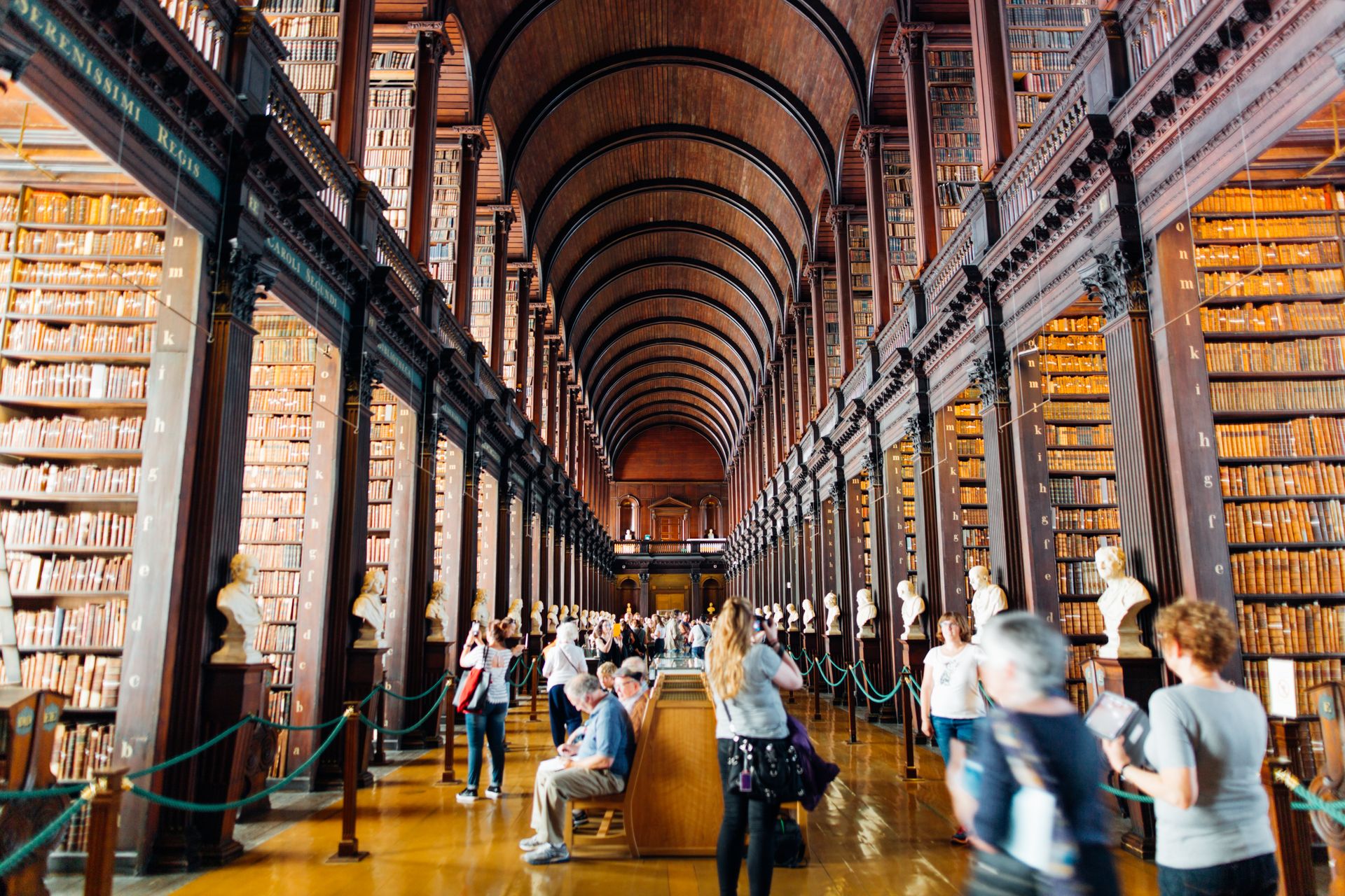 The Long Room of Trinity College Library, Dublin — oak shelves and a barrel-vaulted ceiling.